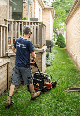 Landscaper mowing lawn